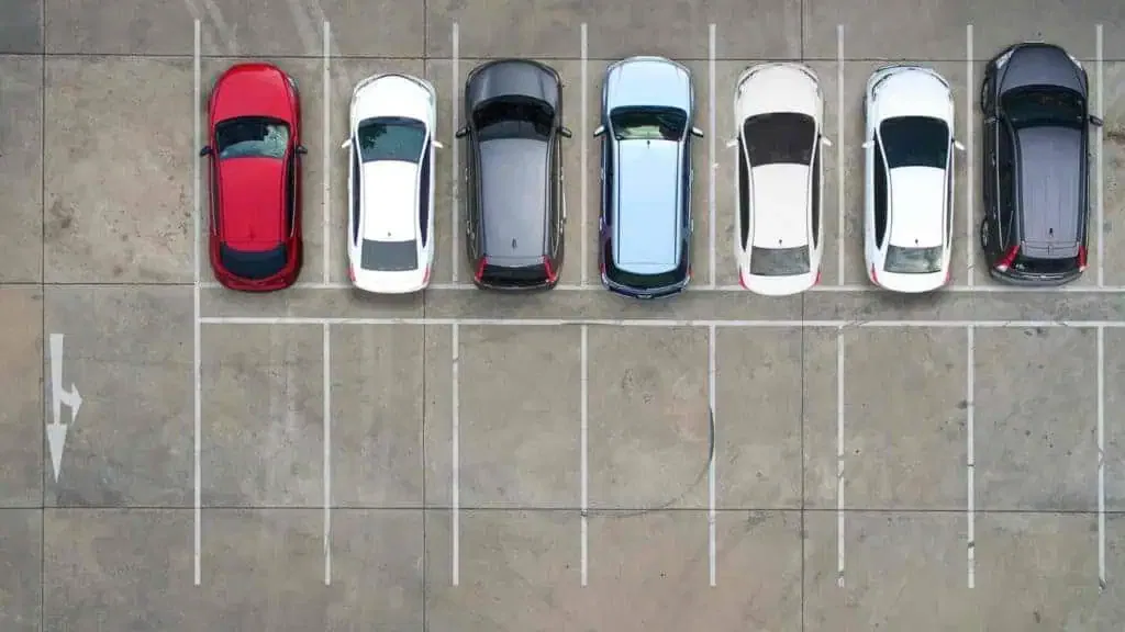 A group of cars parked in a parking lot.