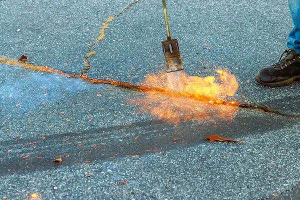using hot crack sealing for damaged asphalt