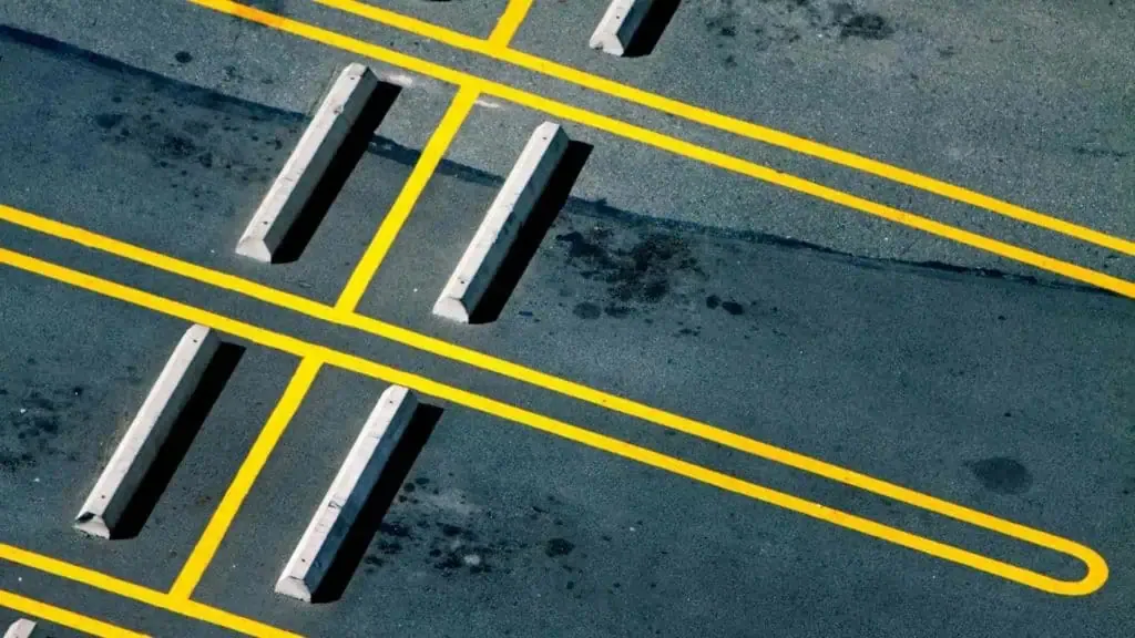 An aerial view of a parking lot with yellow lines.