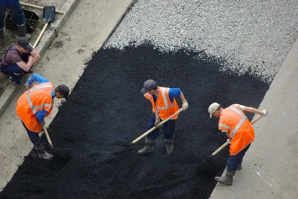 contractors repairing asphalt road
