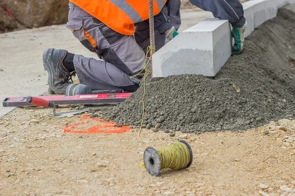 contractor fixing concrete curb